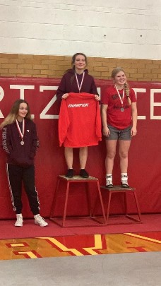 Lady wrestlers on podium